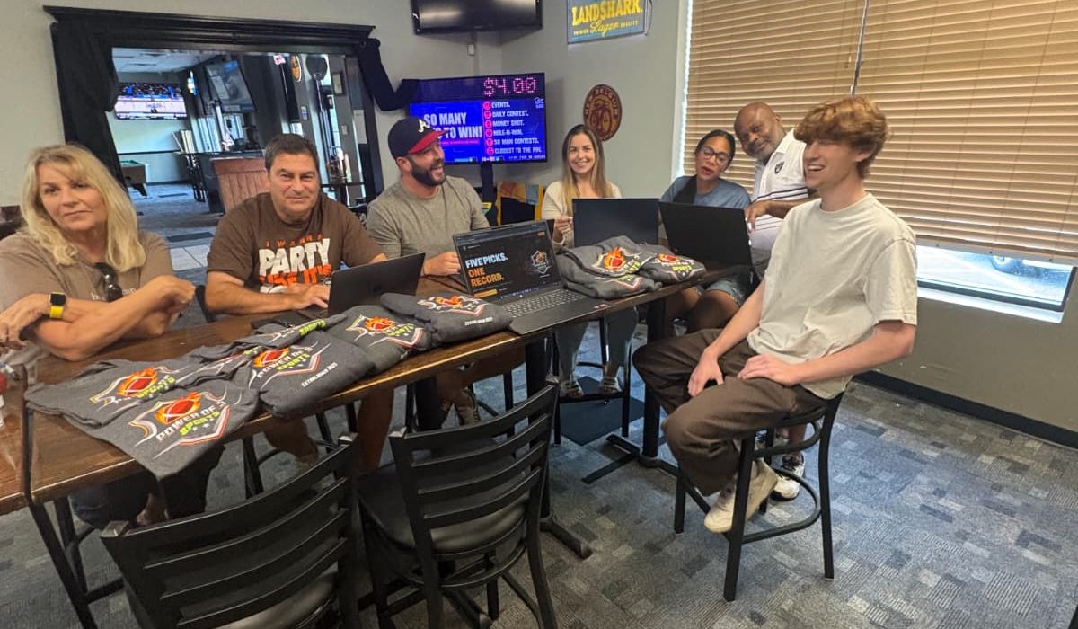 The Power of 3 Sports research and development team working together at a table